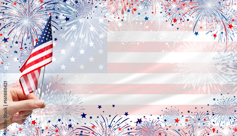 Obraz premium Woman hand holding USA flag on fireworks background for 4 july independence day