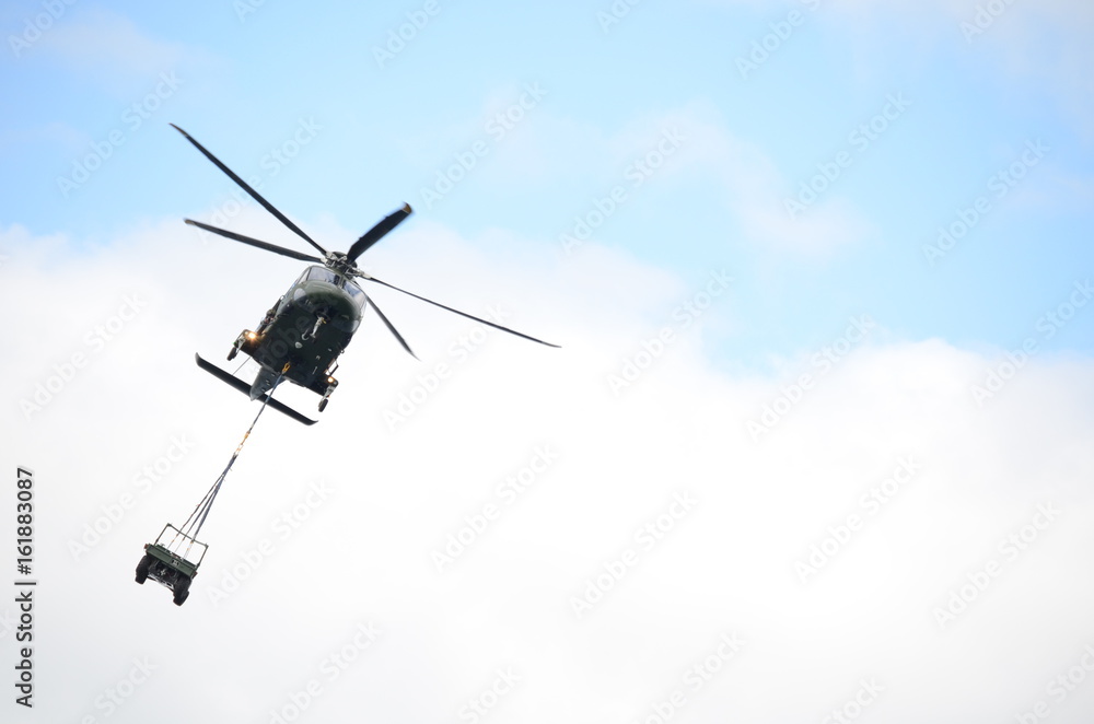 Green Military Helicopter Carrying a Jeep Green Military Helicopter Carrying a Jeep