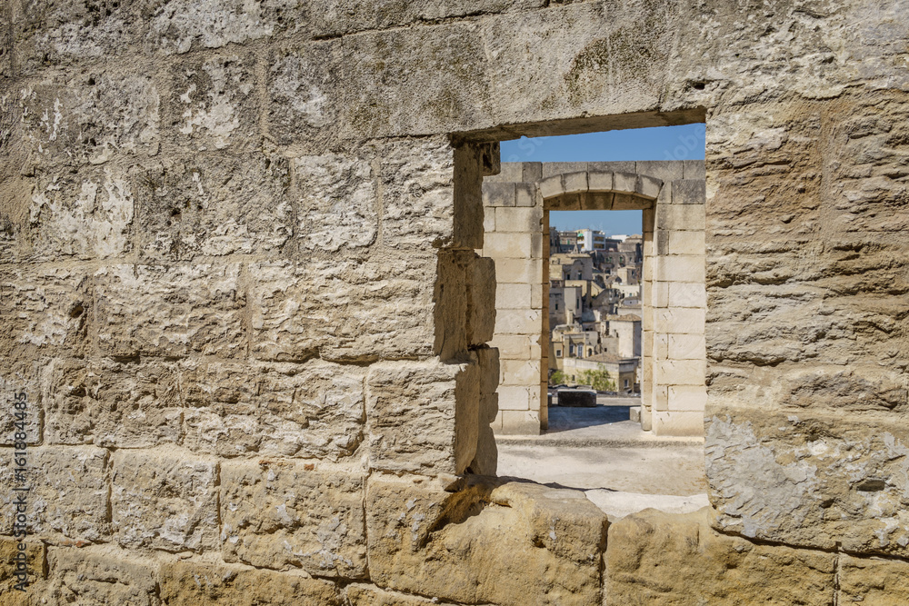 View of ancient stone wall with windows in row in Matera, south Italy View of ancient stone wall with windows in row in Matera, south Italy