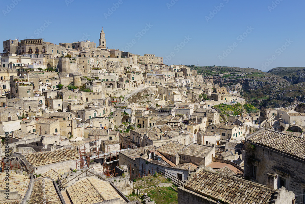 amazing panorama view of ancient ghost town of Matera (Sassi di Matera) in bright sun shine summer with blue sky, south Italy