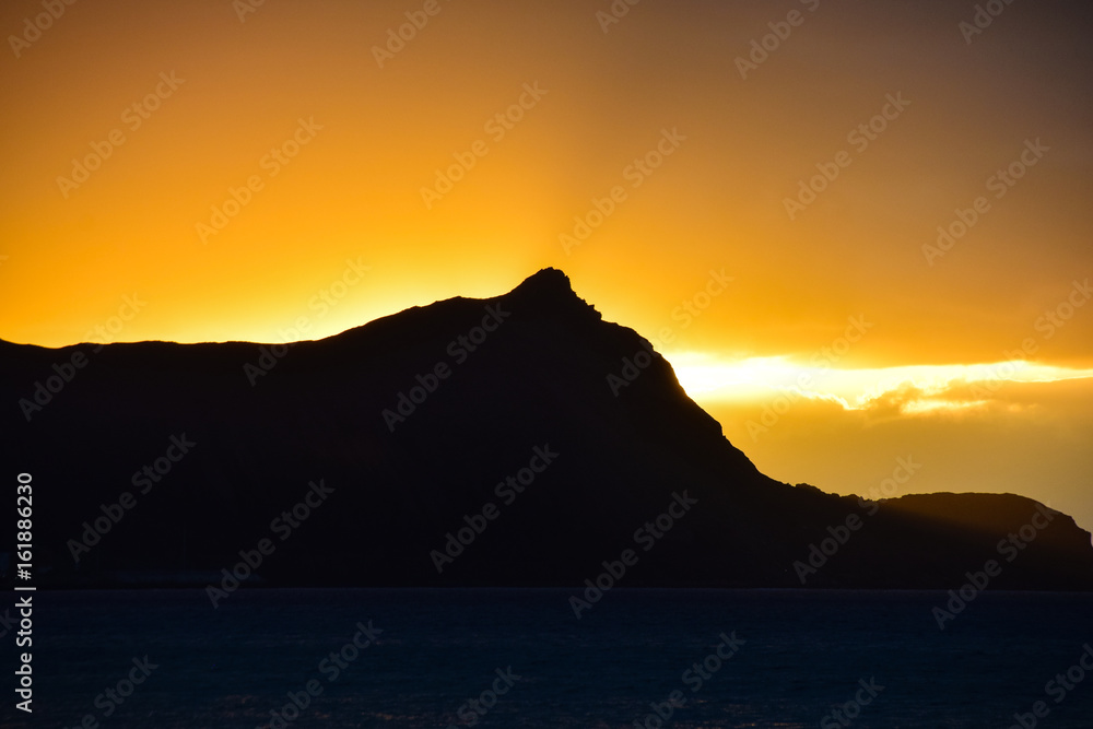 Sunrise over the headland on Porto Santo Island Beach, Madeira, Portugal