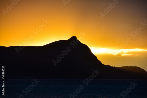 Sunrise over the headland on Porto Santo Island Beach, Madeira, Portugal