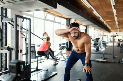Fit man taking break from working out