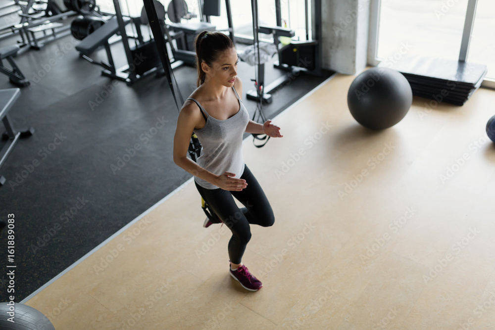 Young beautiful woman doing exercises in gym Young beautiful woman doing exercises in gym