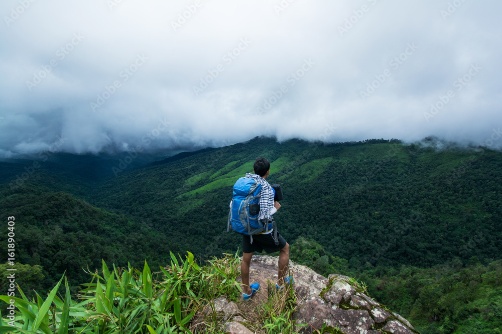 backpacker enjoy beautiful view on top of the mountain