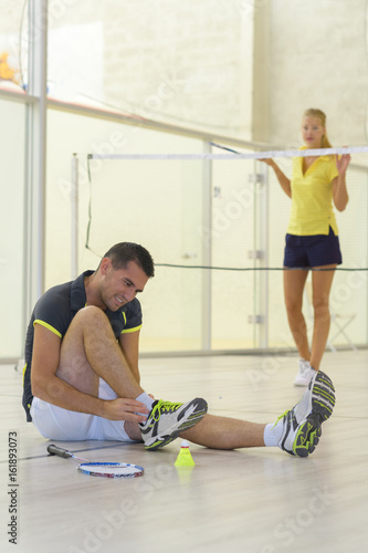 couple playing badminton indoors photo