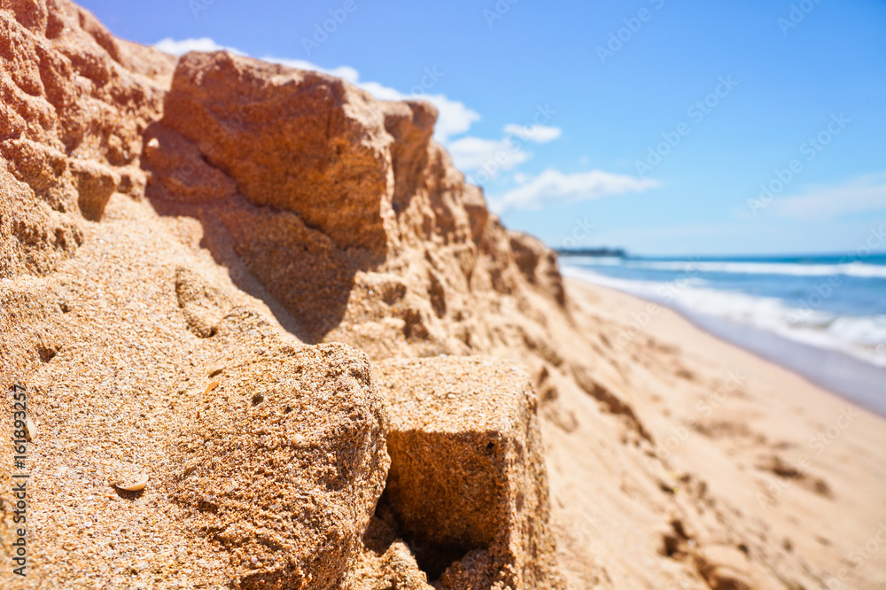 Blurred yellow Mountains of sand on the backdrop of a beautiful Indian Ocean, sea. Untouched tropical beach in Sri Lanka. Stock photo for design