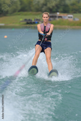 Fototapeta Naklejka Na Ścianę i Meble -  young woman water skiing on a sea