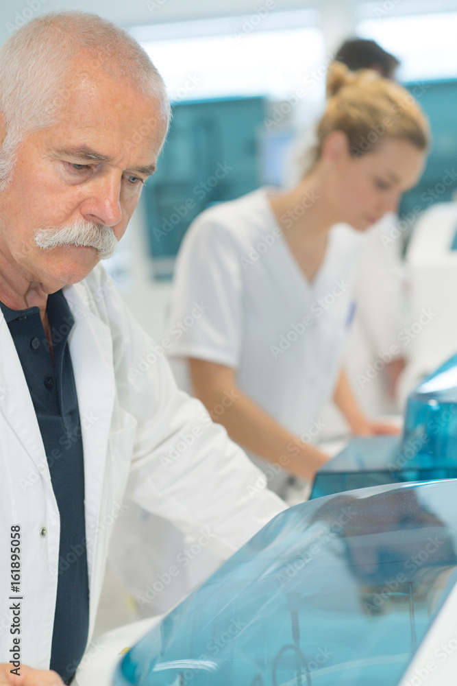 mature scientist working with samples in lab mature scientist working with samples in lab