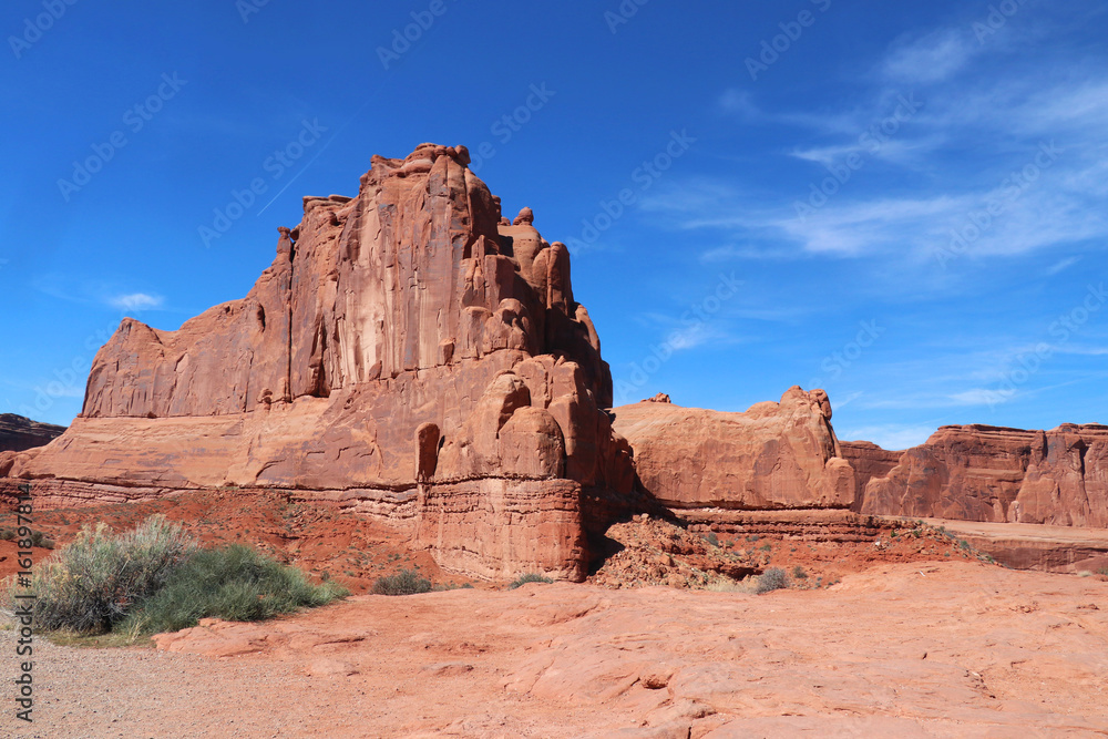 Amazing Utah landscape with red sandstones in Arches National Park, Moab, Utah, USA. Nature red sandstone rock formations against bright blue sky. Nature background.