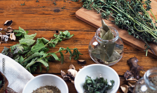 Homegrown fresh and dry herbs composition on rustic table
