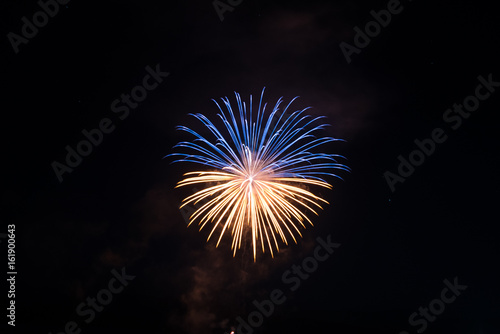 Beautiful single firework in gold and blue