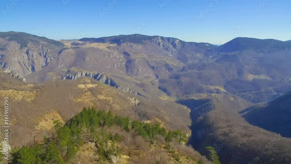 aerial panorama of mountains and road in sunny day aerial panorama of mountains and road in sunny day