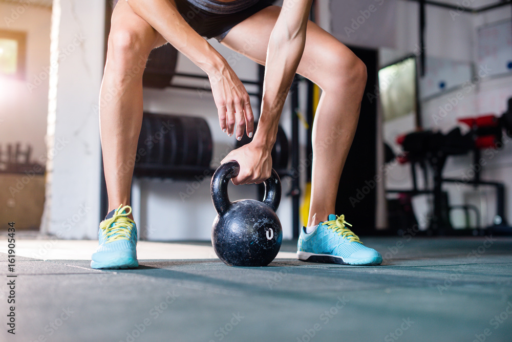 Naklejka premium Woman doing kettlebell exercise