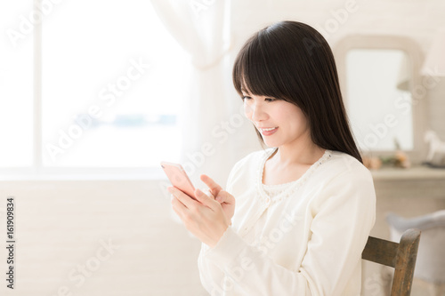 Free Download attractive asian woman using smart phone - GFXLoad