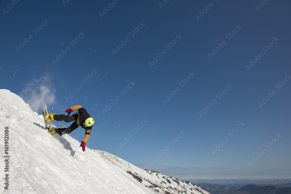 Snowboarder falling down in snow mountain