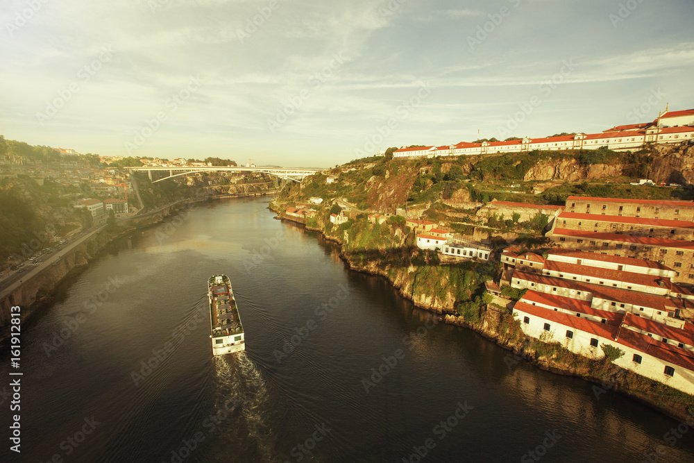 Boat on Douro river in Porto city, Portugal. European skyline