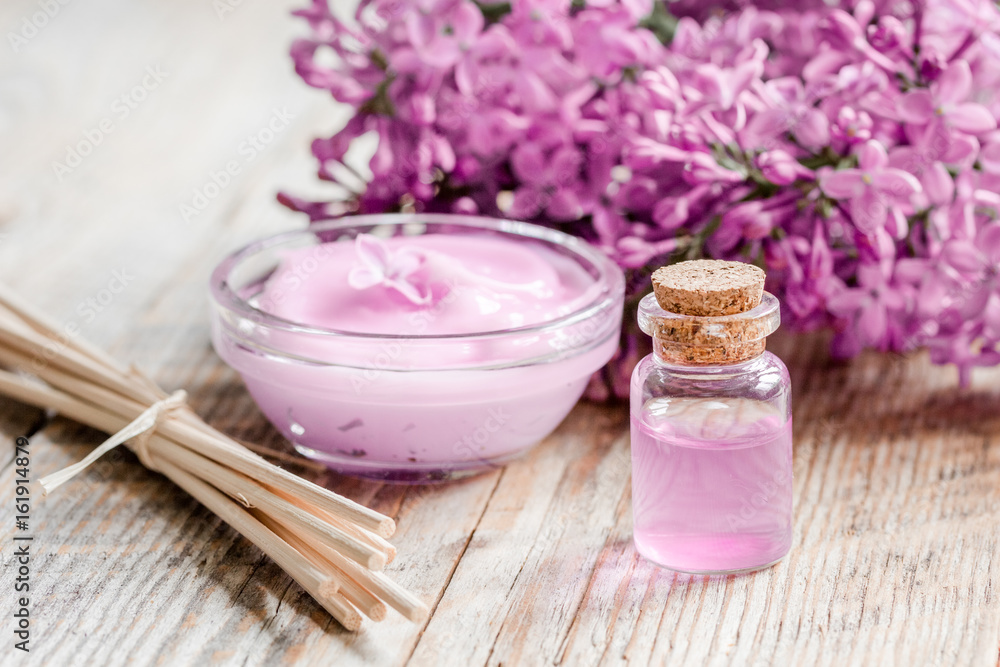 lilac natural cosmetic set for spa with oil wooden table background lilac natural cosmetic set for spa with oil wooden table background