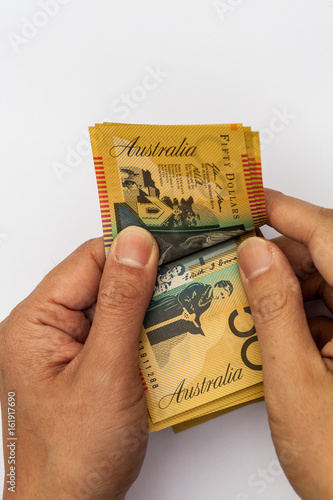 Male hands counting Australian $50 dollar notes photo