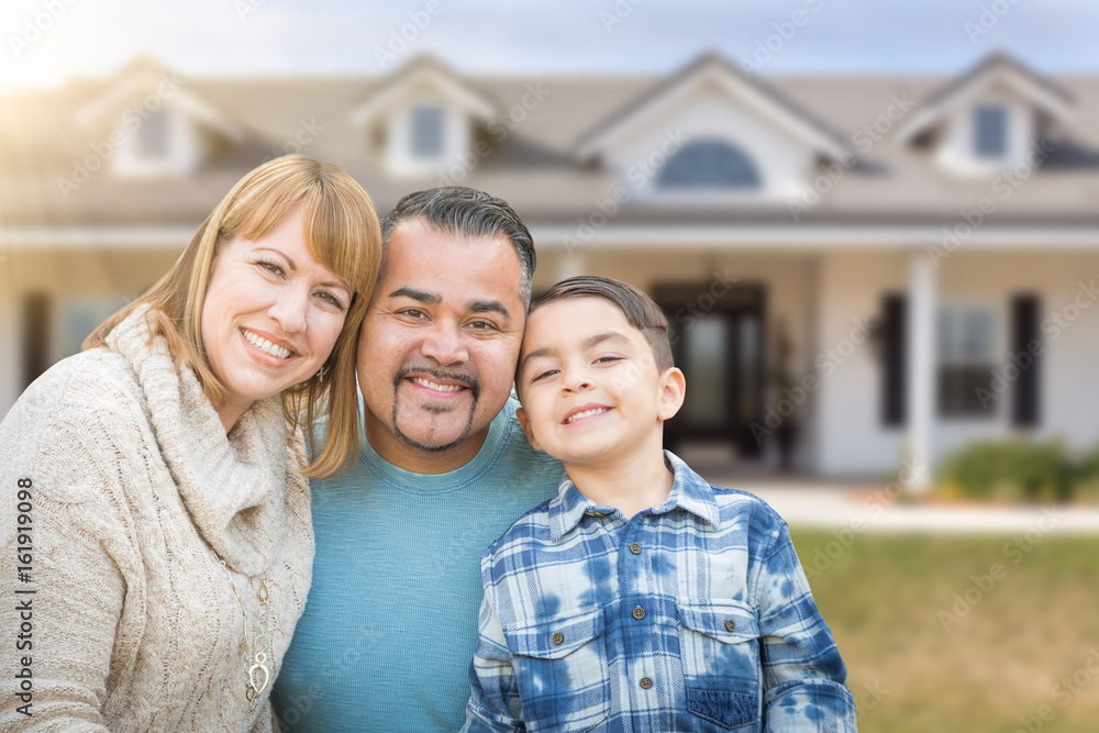 Mixed Race Family In Front Yard of Beautiful House and Property.