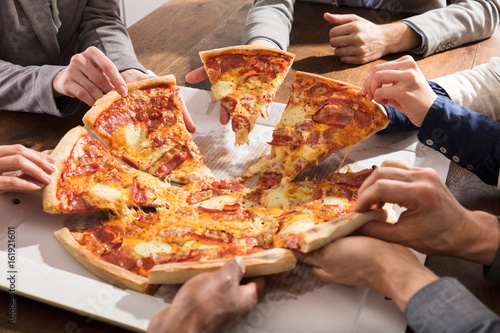 Group Of Businesspeople Eating Pizza