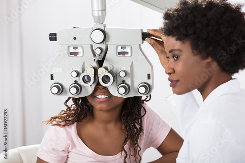 Fototapeta Naklejka Na Ścianę i Meble -  Optometrist Doing Sight Testing For Patient