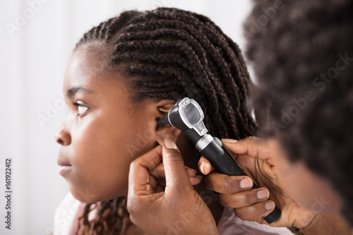 Doctor Checking Girl Ear In Hospital photo
