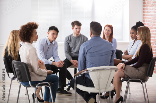 Group Of Businesspeople Sitting On Chair