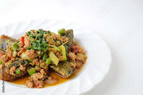 stir fired minced pork with basil top on fired preserved egg. photo