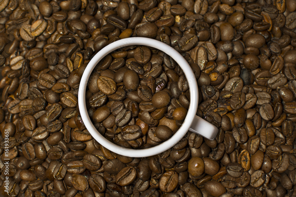 Coffee beans texture. Warm cup of coffee background.