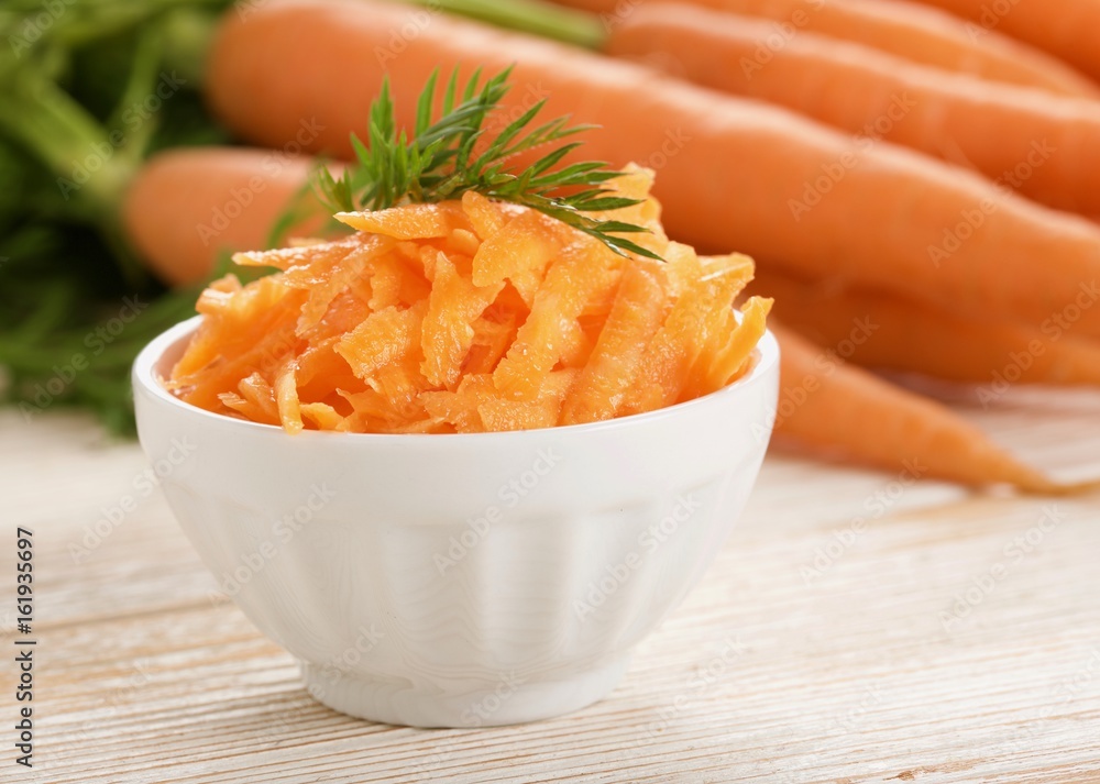 grated carrot on wooden background grated carrot on wooden background