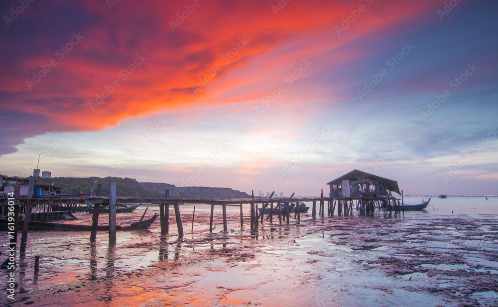Long Exposure shot of Jelutong Jetty, Penang, Malaysia during sunrise. Soft focus, motion blur due to long exposure shot