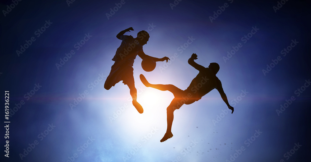 Silhouettes of two soccer players