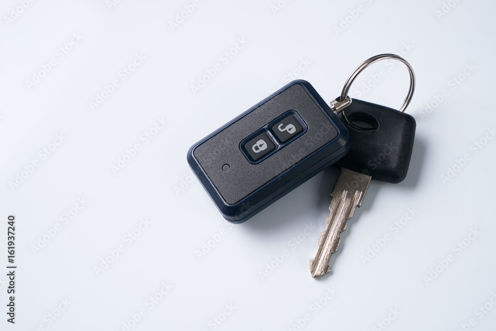 Car key and alarm system charm isolated on a white background with copy spase. car key with remote control Car key and alarm system charm isolated on a white background with copy spase. car key with remote control