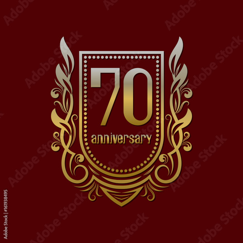 Seventieth anniversary vintage logo symbol. Golden emblem with numbers on shield in wreath.