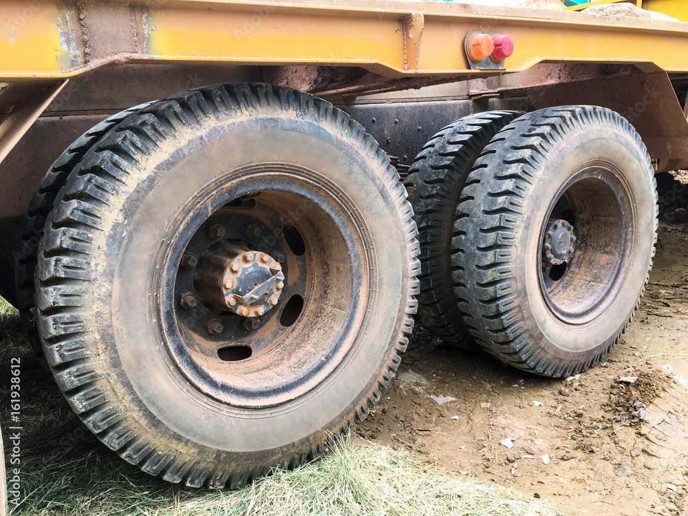 Orange dump truck chassis close to the road Orange dump truck chassis close to the road