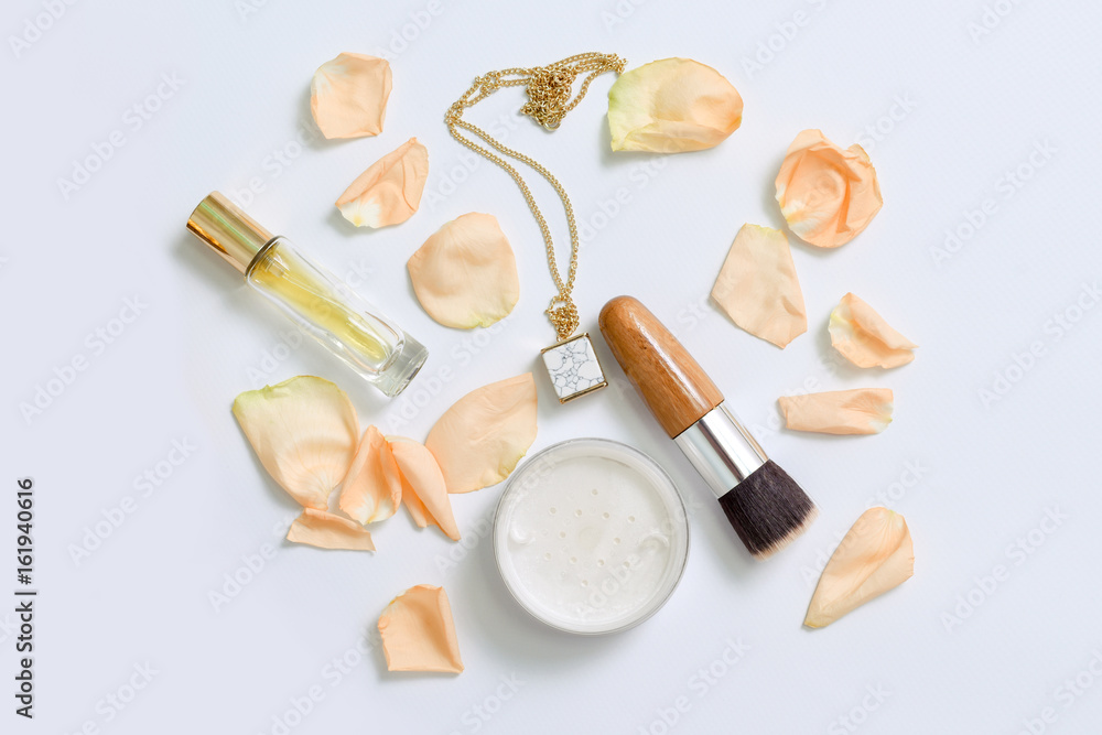 Perfume bottles with flowers petals on white background. Perfumery, cosmetics, jewelry and fragrance collection. Stylized feminine flatlay. Women accessories top view. Perfume bottles with flowers petals on white background. Perfumery, cosmetics, jewelry and fragrance collection. Stylized feminine flatlay. Women accessories top view.