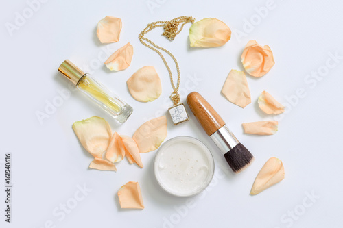 Perfume bottles with flowers petals on white background. Perfumery, cosmetics, jewelry and fragrance collection. Stylized feminine flatlay. Women accessories top view.
