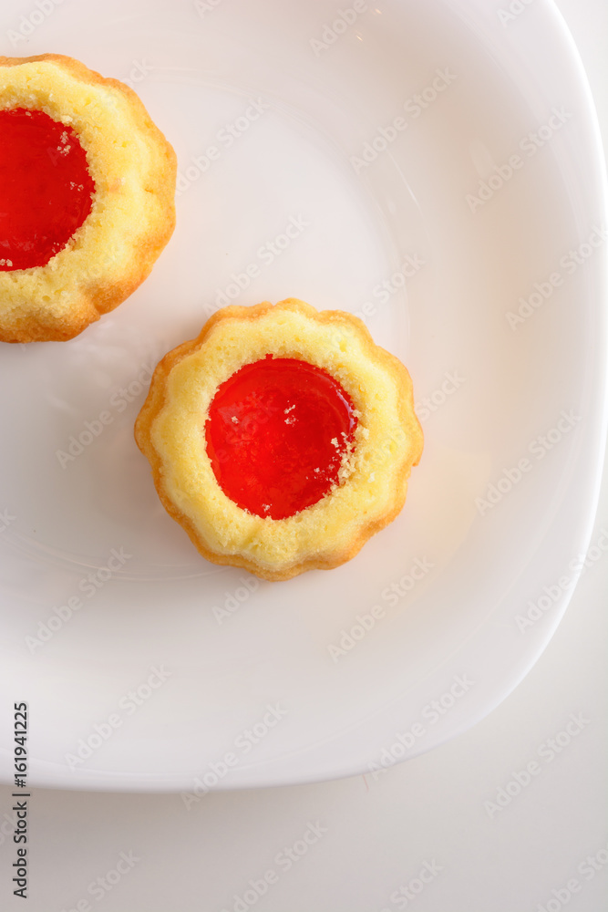 couple of the cookies with strawberry jam on the white plate. Time of tea couple of the cookies with strawberry jam on the white plate. Time of tea