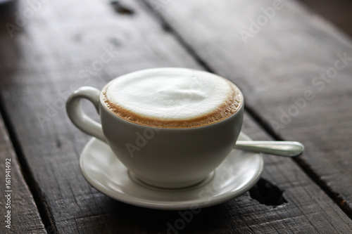 Cup of enery, Cappuccino coffee in white cup on wooden table