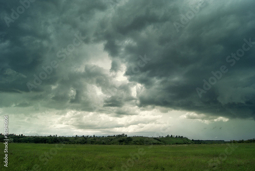 Clouds and rain over fields and forests