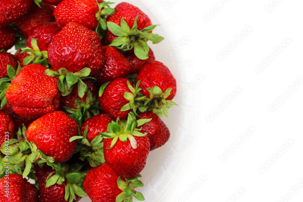 Ripe red strawberries in a dish on a white background Ripe red strawberries in a dish on a white background