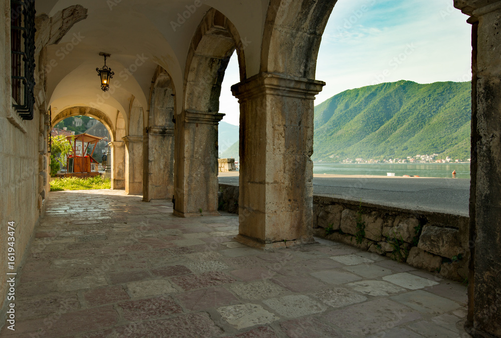 The city of Perast in Montenegro. Arches of the museum overlooking the river and mountains