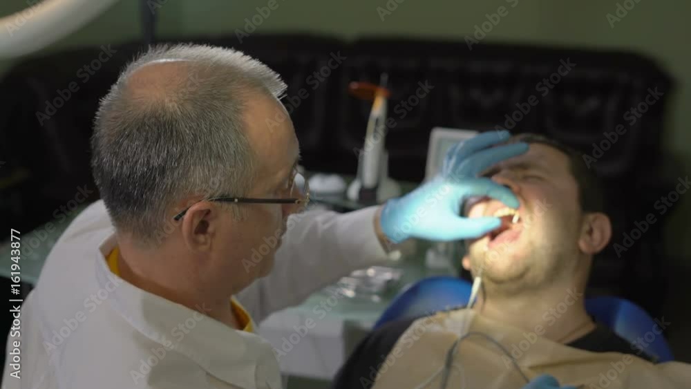CloseUp,the Dentist Inserts the File Into the Root Canal of the