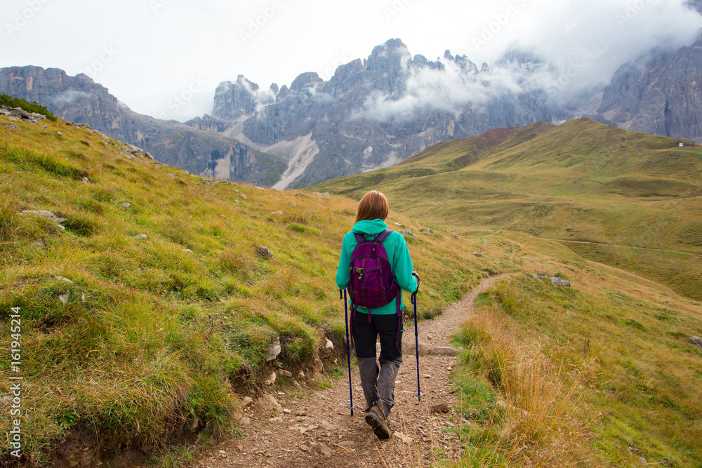 girl hiker on a trail at the Dolomites