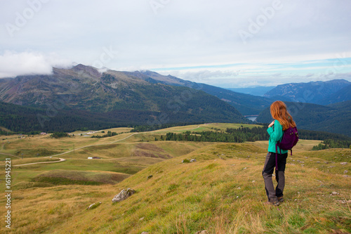 girl hiker on a trail at the Dolomites