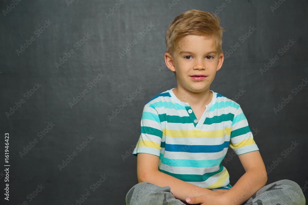 Boy posing with blackboard behind him Boy posing with blackboard behind him