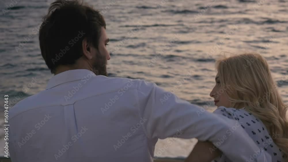 Young in love couple quarrels near the ocean