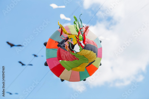 kites flying in a blue sky. Kites of various shapes.
