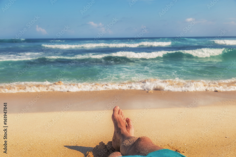 Fototapeta premium Man enjoying at the beach - focus is on feet.